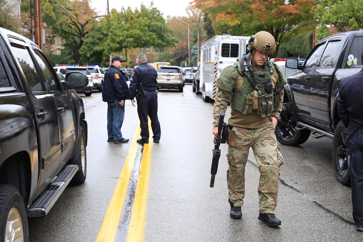 A SWAT police officer and other first responders are seen Oct. 27 after a gunman killed at least four people at the Tree of Life Synagogue in Pittsburgh. Robert Bowers opened fire that morning during a service at the synagogue, also wounding at least six others, including four police officers, authorities said.
